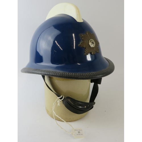 11 - A 1970s Norwegian Fire Service blue fibreglass fire helmet with white comb and mounted badge