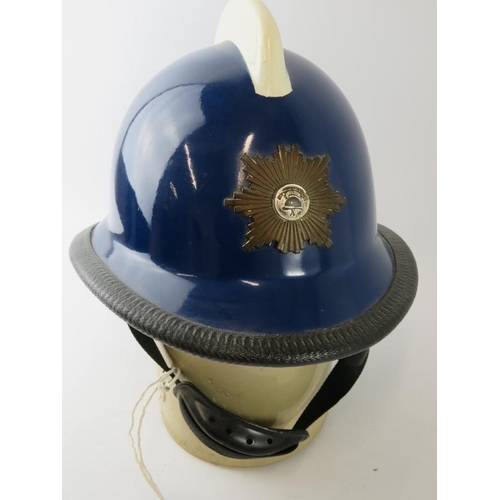 11 - A 1970s Norwegian Fire Service blue fibreglass fire helmet with white comb and mounted badge