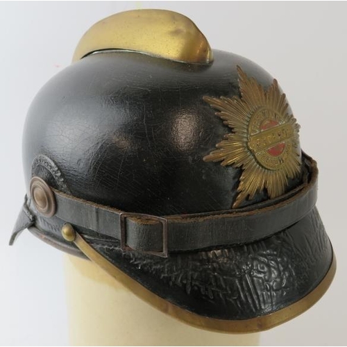 115 - A late 19th/early 20th century German Eschede Fire Brigade leather fire helmet with brass mounts, la... 