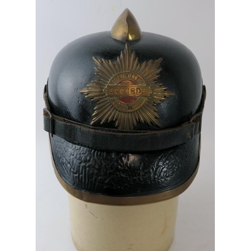 115 - A late 19th/early 20th century German Eschede Fire Brigade leather fire helmet with brass mounts, la... 