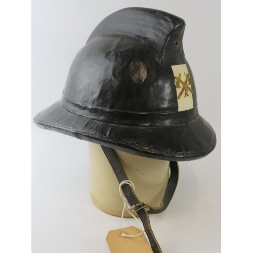 15 - A 1970s Belgian Fire Service black cork fire helmet with brass badge.