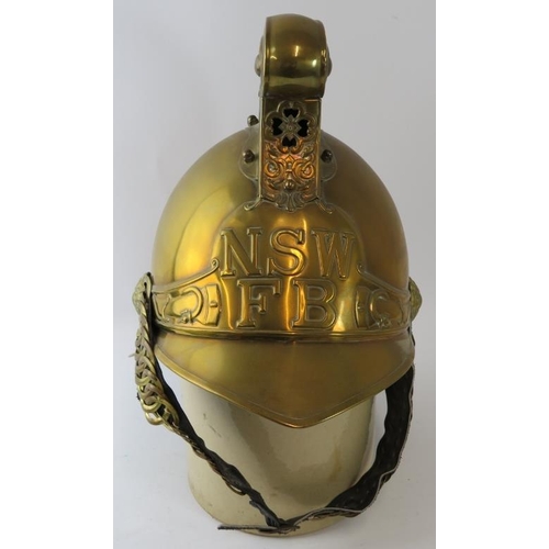 17 - An Australian New South Wales Fire Service replica brass fire helmet with chain link chin strap, cir... 