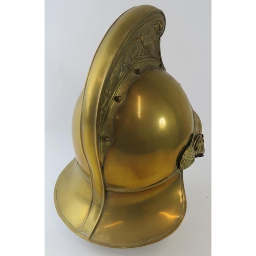 17 - An Australian New South Wales Fire Service replica brass fire helmet with chain link chin strap, cir... 