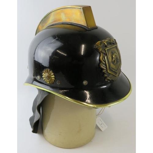 2 - A 1970s Dutch Fire Service black steel fire helmet with brass mounts and leather neck cowl