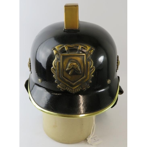 2 - A 1970s Dutch Fire Service black steel fire helmet with brass mounts and leather neck cowl