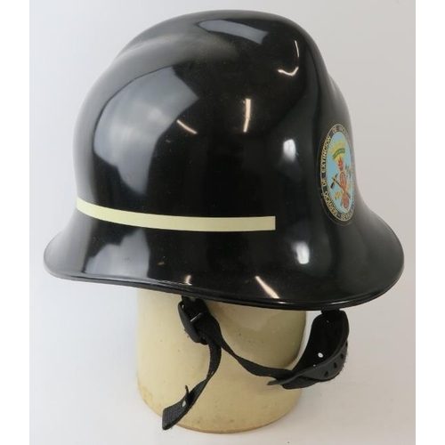 20 - A 1970s Spanish Seville Fire Service ABS black fire helmet.