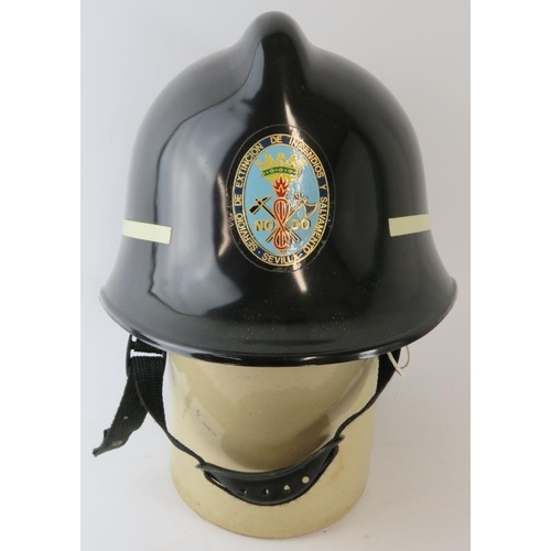 20 - A 1970s Spanish Seville Fire Service ABS black fire helmet.