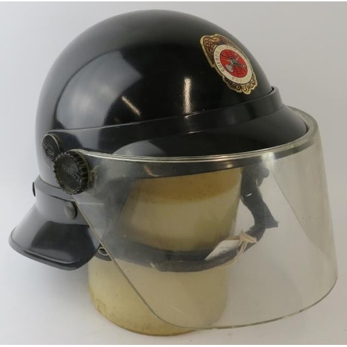 23 - A 1980s Panama Fire Service black ABS fire helmet with visor