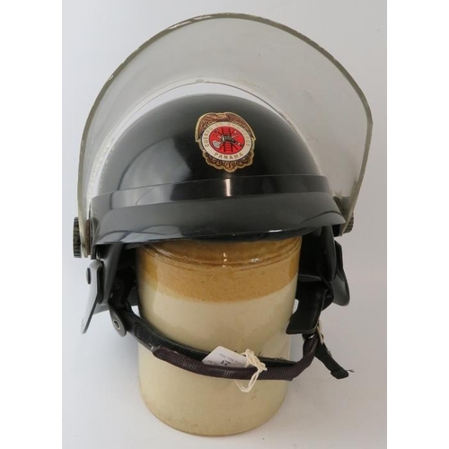 23 - A 1980s Panama Fire Service black ABS fire helmet with visor