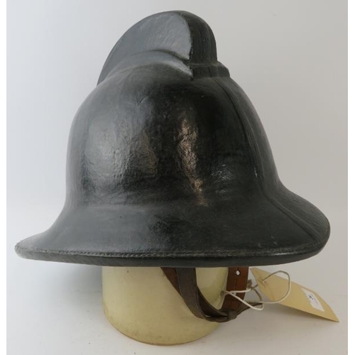 26 - A 1970s British black cork fire helmet (unbadged)