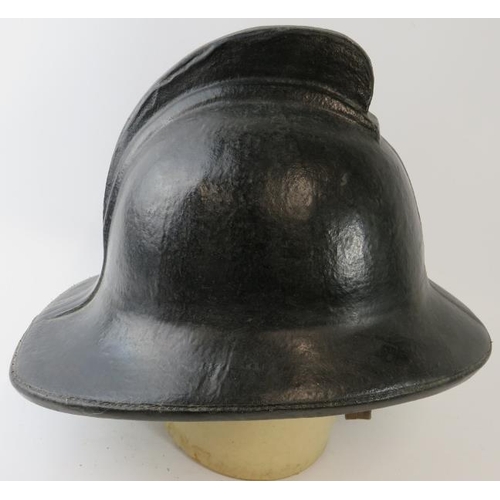 26 - A 1970s British black cork fire helmet (unbadged)