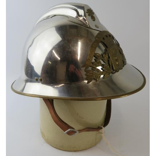 30 - A 1970s French Sapeurs Pompiers Fire Service polished chrome fire helmet with brass mounts.