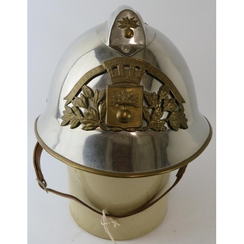 30 - A 1970s French Sapeurs Pompiers Fire Service polished chrome fire helmet with brass mounts.