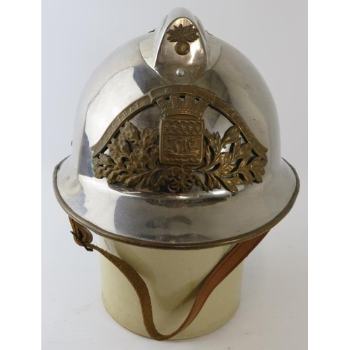 31 - A 1980s French Paris Fire Service polished chrome fire helmet with brass mounts