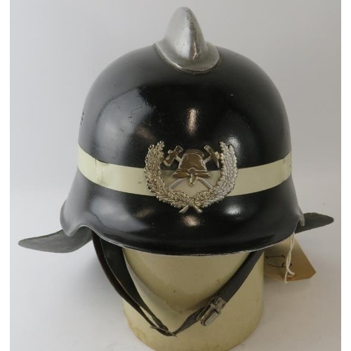 38 - An unusual 1970s German pattern Spanish Fire Service black fire helmet with polished metal comb and ... 