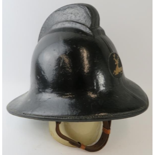 39 - A 1970s British Hertfordshire Fire Brigade fire helmet with brass stag emblem.