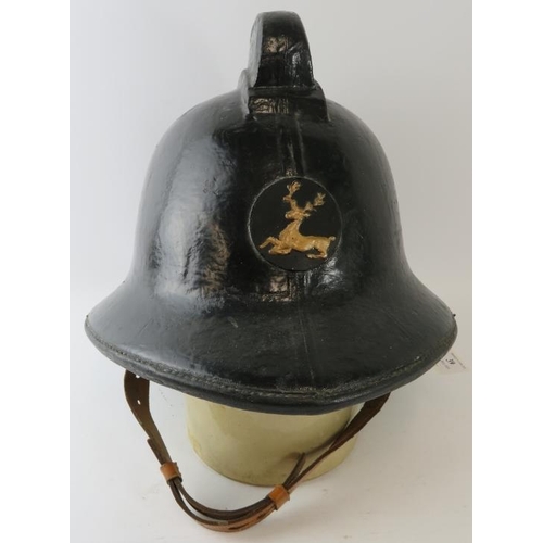 39 - A 1970s British Hertfordshire Fire Brigade fire helmet with brass stag emblem.