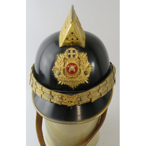 4 - A Greek Athens Fire Brigade black steel fire helmet with brass mounts and badge