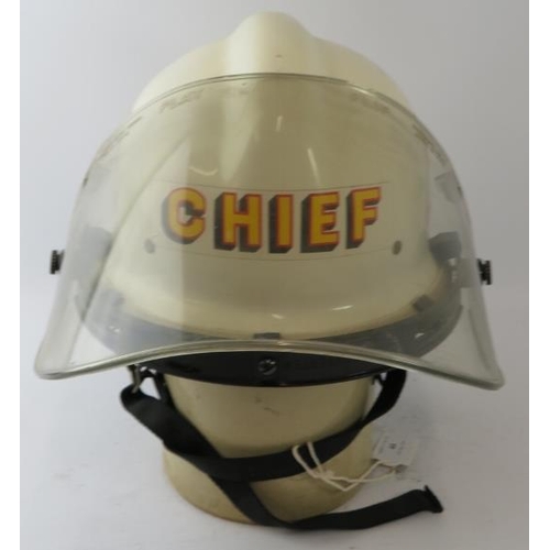 44 - A 1970s American US Fire Department white Fire Chief's helmet with visor.