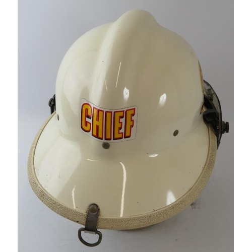 44 - A 1970s American US Fire Department white Fire Chief's helmet with visor.