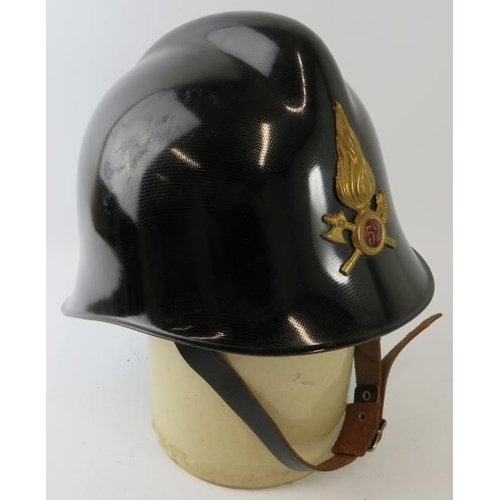 46 - A 1980s Italian Fire Service black carbonfibre fire helmet with brass badge