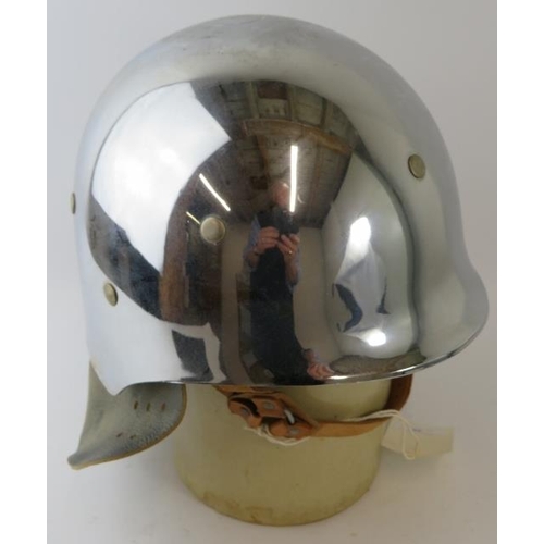 48 - A 1980s West German polished chrome fibreglass fire helmet with leather neck cowl