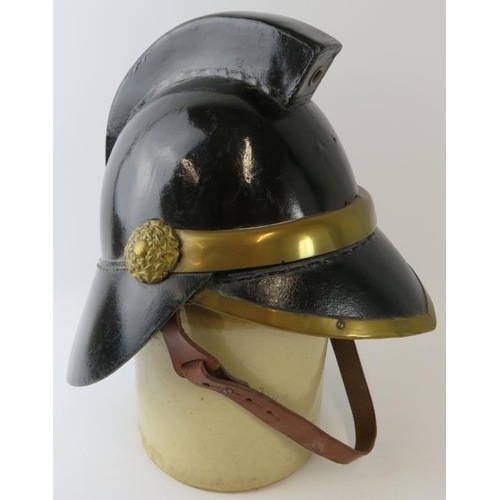 5 - A 1920s British leather and brass fire helmet with square comb