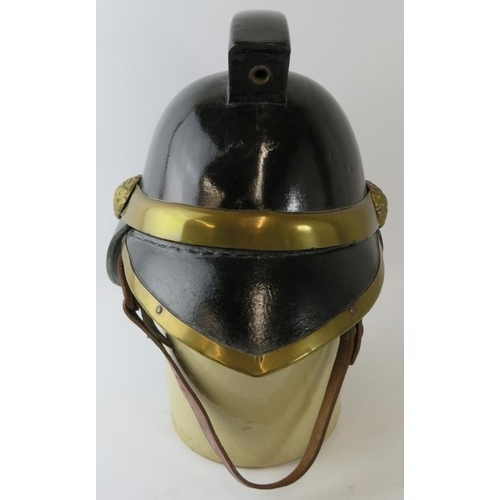 5 - A 1920s British leather and brass fire helmet with square comb