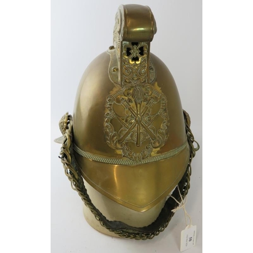 50 - An early 20th century British brass Merryweather fire helmet with chin strap.