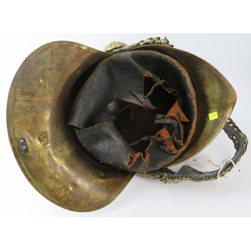 50 - An early 20th century British brass Merryweather fire helmet with chin strap.