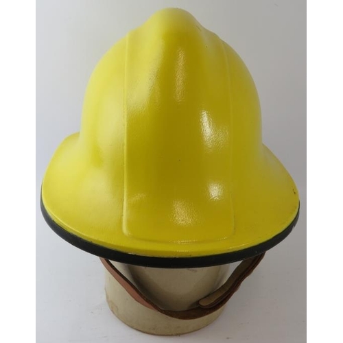 56 - A 1990s British yellow trial fire helmet (unbadged)