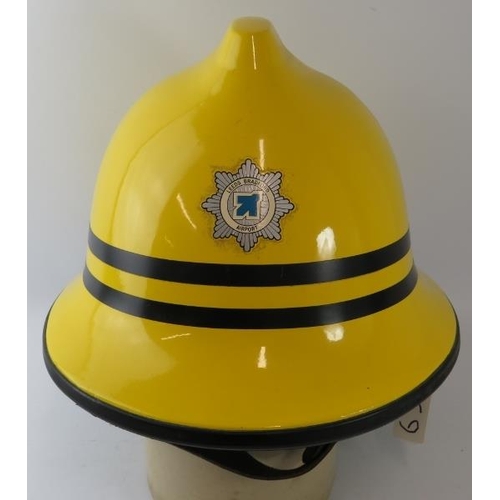 57 - A 1990s British Cromwell Firepro yellow fire helmet with Leeds Bradford Airport badge