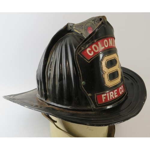 63 - A 1950s American steel beaver tail fire helmet badged for Colonial Fire Co. Manufactured: Cairns & B... 