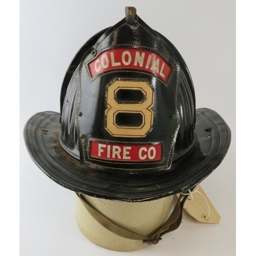 63 - A 1950s American steel beaver tail fire helmet badged for Colonial Fire Co. Manufactured: Cairns & B... 