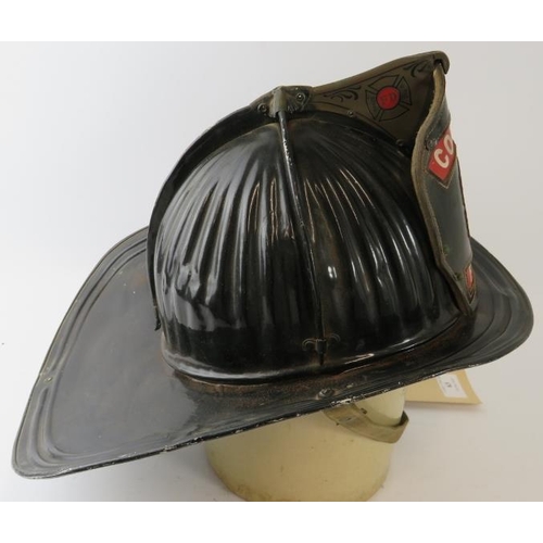 63 - A 1950s American steel beaver tail fire helmet badged for Colonial Fire Co. Manufactured: Cairns & B... 