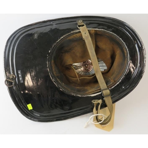 63 - A 1950s American steel beaver tail fire helmet badged for Colonial Fire Co. Manufactured: Cairns & B... 