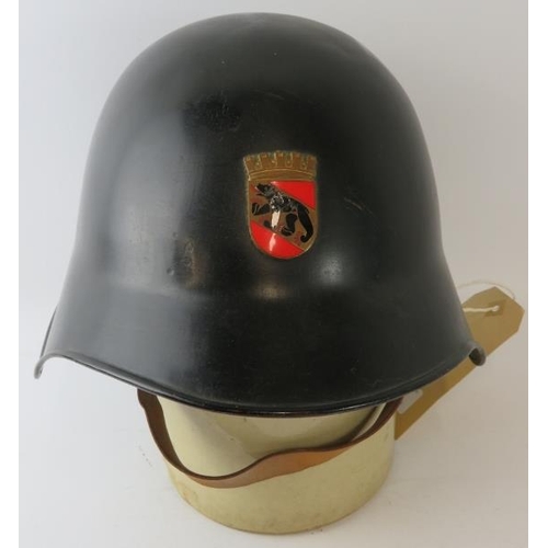 64 - A 1970s Swiss Bern Fire Service black steel fire helmet