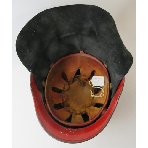 9 - A 1960s German steel red fire helmet with leather neck cowl