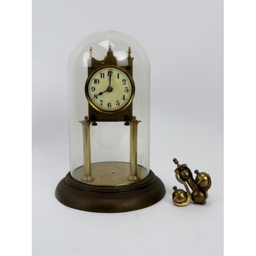 150 - A brass torsion pendulum clock with glass dome, early 20th century. 28 cm total height. 
Condition r... 