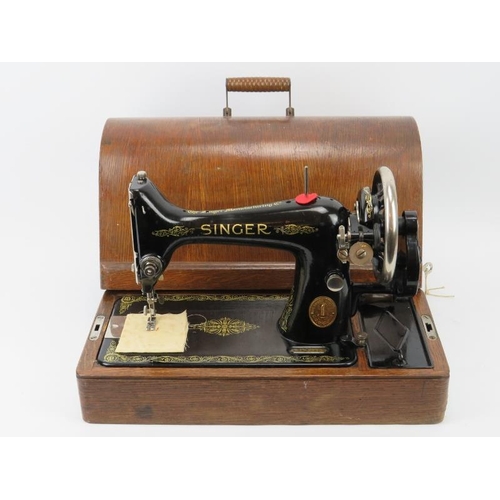 152 - A vintage Singer sewing machine, circa 1929. Painted black with gilt scrolling foliate decoration. M... 