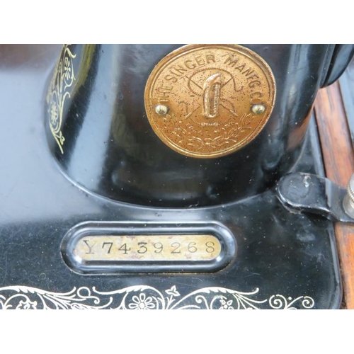 152 - A vintage Singer sewing machine, circa 1929. Painted black with gilt scrolling foliate decoration. M... 