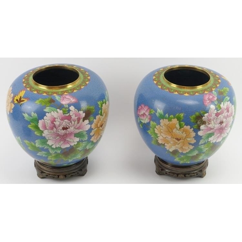 18 - A large pair of Chinese cloisonné enamelled vases and covers, 20th century. Supported on carved wood... 