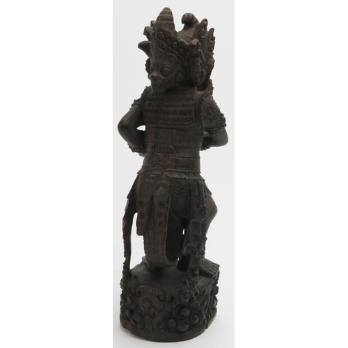 21 - A South East Asian carved head and figural statue, probably Indonesia/Bali, 20th century. 20 cm heig... 