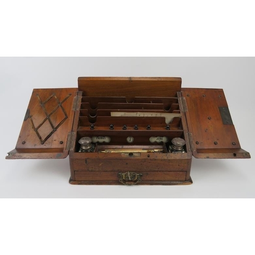 226 - A Victorian mahogany desk top cabinet. The sloped double doors open to reveal a letter rack, perpetu... 