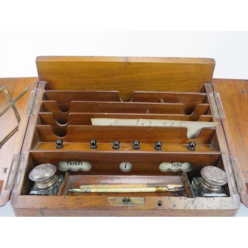 226 - A Victorian mahogany desk top cabinet. The sloped double doors open to reveal a letter rack, perpetu... 