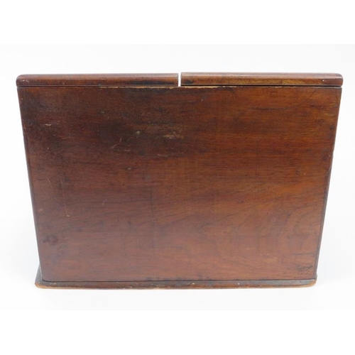 226 - A Victorian mahogany desk top cabinet. The sloped double doors open to reveal a letter rack, perpetu... 