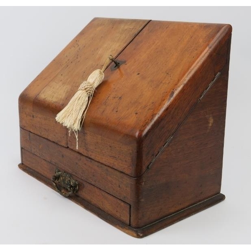 226 - A Victorian mahogany desk top cabinet. The sloped double doors open to reveal a letter rack, perpetu... 