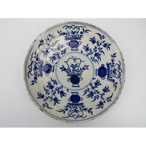 235 - A Delft blue and white florally decorated dish, probably 18th century. 21.8 cm diameter. Condition r... 