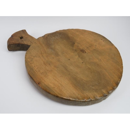 249 - Treen: A large antique carved sycamore kitchen chopping block. 52.3 cm length. Condition report: Som... 