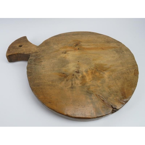 249 - Treen: A large antique carved sycamore kitchen chopping block. 52.3 cm length. Condition report: Som... 